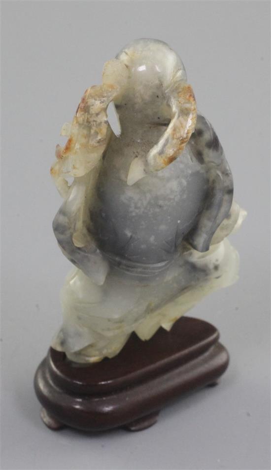 A Chinese white and black jade figure of an old man, 18th / 19th century, 7.3cm, wood stand